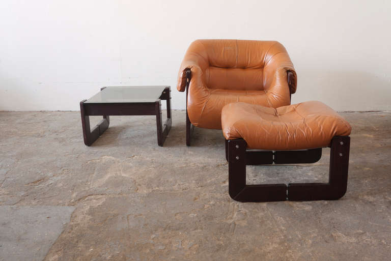 A Mid-Century Modern set by Percival Lafer, includes a smoked glass side table, leather ottoman and lounge chair. Sold as a set, the leather has aged quite nicely and is all original.