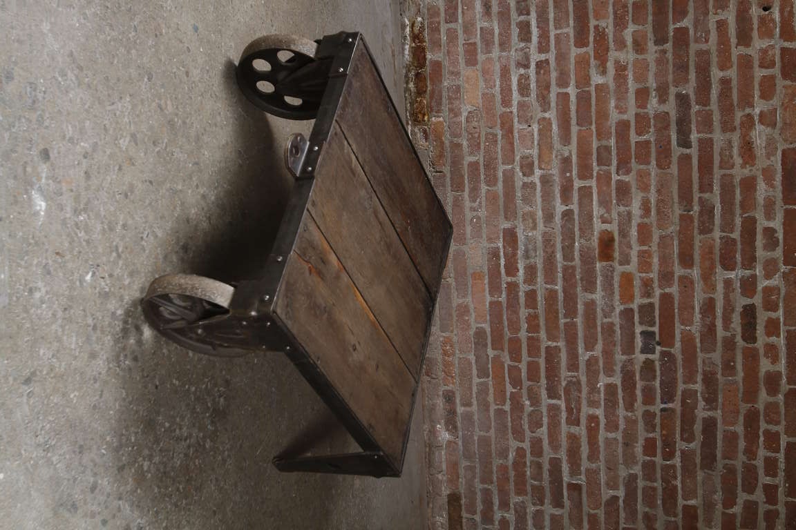 American wood and antique factory wheels reclaimed and recently finished into an industrial coffee table.