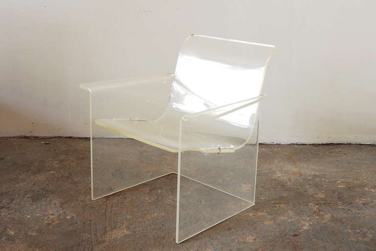 Made of just two interlocking elements, this chair visually defines the basic necessities of structure and seat. Entirely made of acrylic, this piece occupies minimal visual space while providing maximum stability (and is surprisingly comfortable).