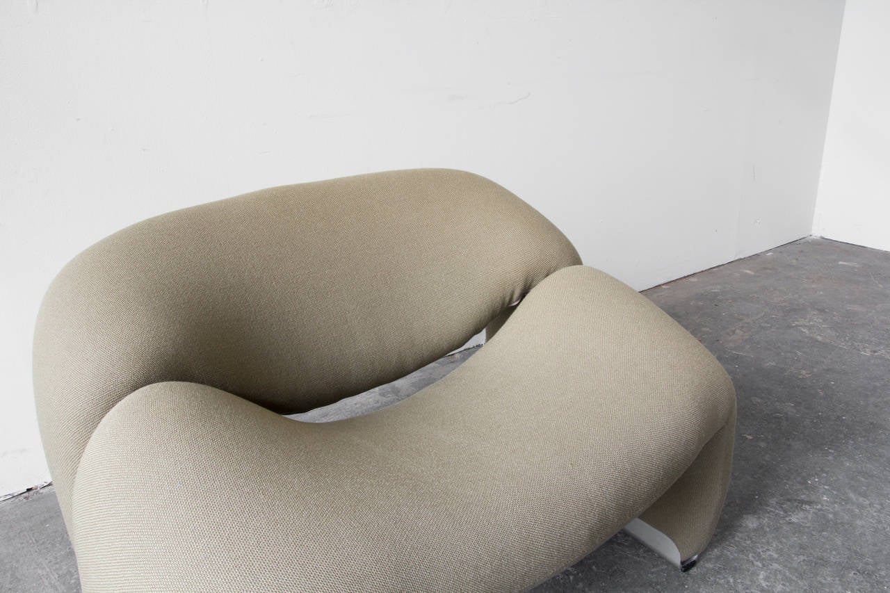 A sumptuous upholstered easy chair by Pierre Paulin for Artifort. It's playful curves translate to serious comfort in just about any position. The upholstered legs are capped at the floor with aluminum glides.