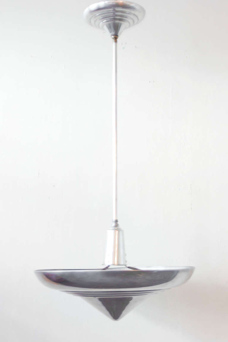 This Deco fixture is perfectly streamlined, from its conical tip through to its flaring peak. Its light weight and heavy feel add to its appeal, which works in the home just as well as it does in the diner.