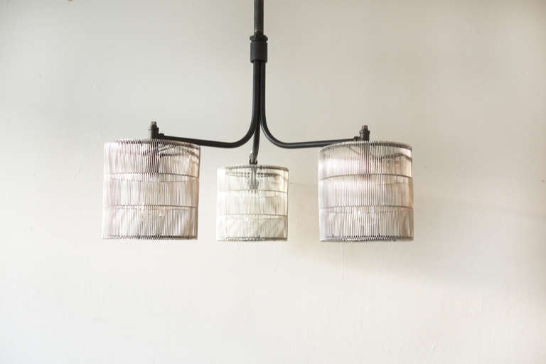 A three shade ceiling lamp made from repurposed conveyor belt.