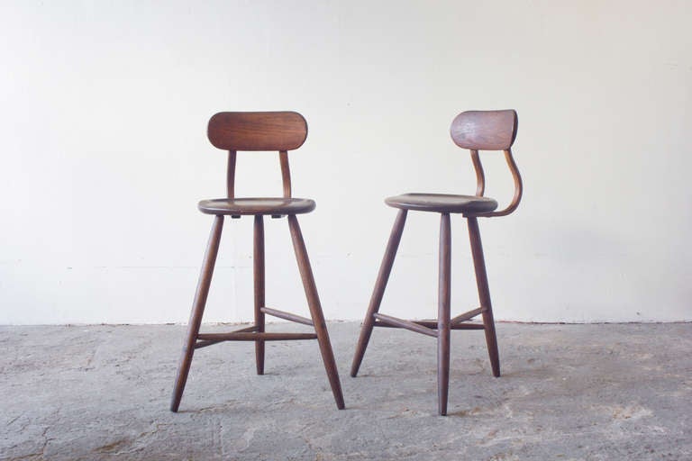 A pair of mid - century inspired bar stools with Kai Pedersen carved into the bottom of the seat. We picked these up in PA and after doing a bit of research found that they were made in Lancaster, Pennsylvania in the eighties.