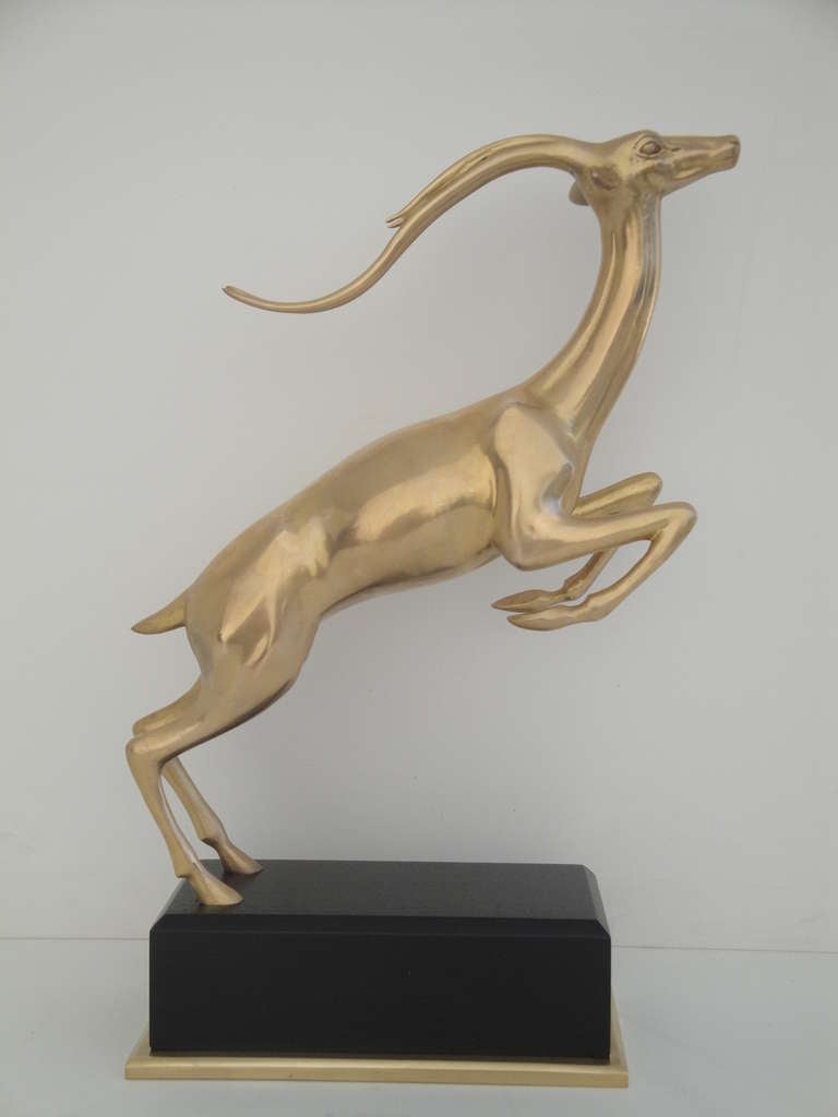 Hollywood Regency brass Impala statue on wooden base
Two available, priced is per item.
