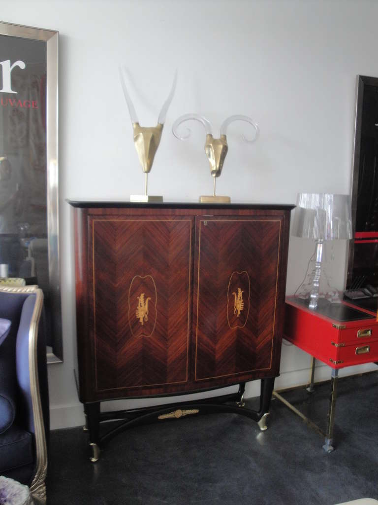 Rosewood bar cabinet style of Paolo Buffa with mirror and glass interior and polished brass sabot feet. We also have matching rosewood sideboard or buffet cabinet.