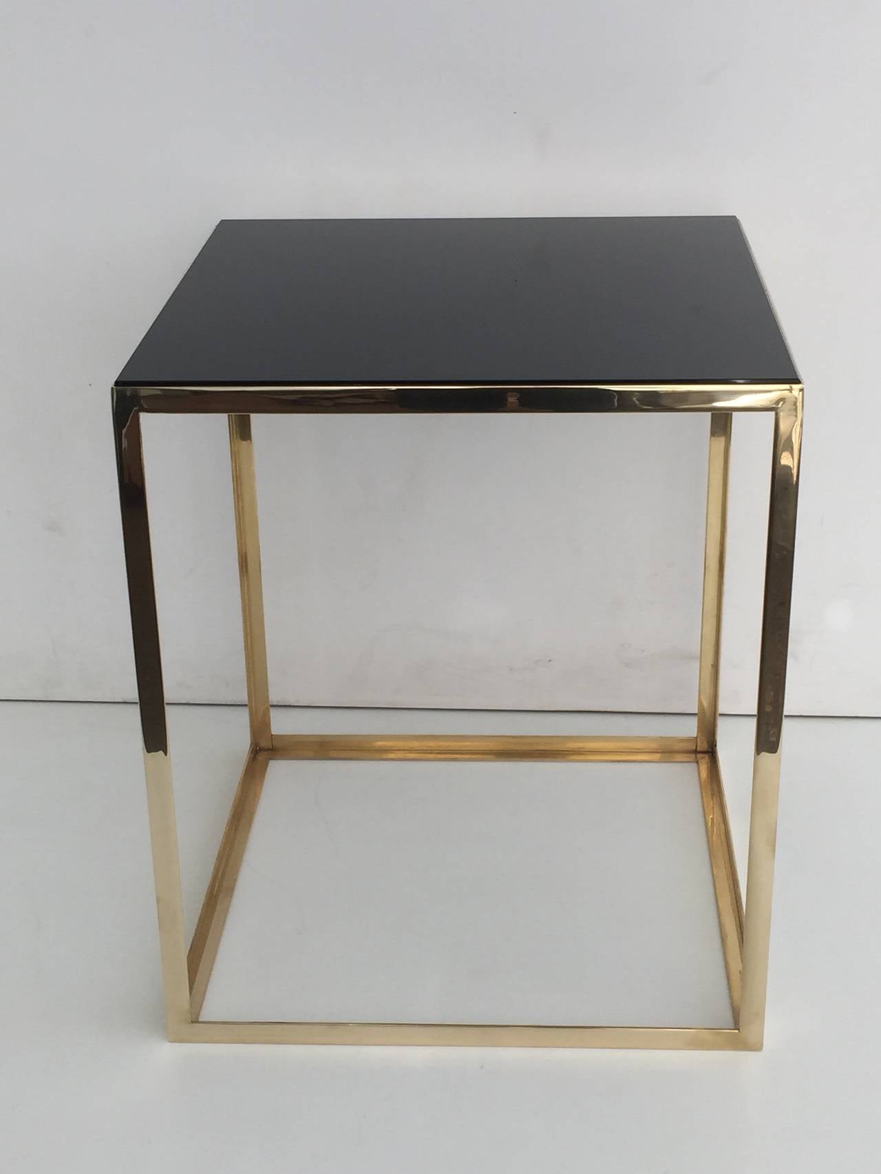 Pair of brass and black glass cube tables.