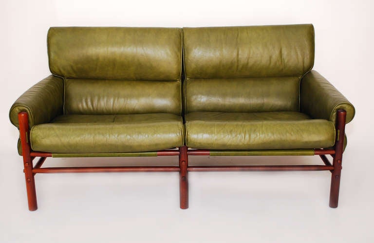 Completely original stunning olive green Arne Norell safari settee and ottoman. Made of European beachwood frame and olive green leather and brass buckles. 

Ottoman dimensions: 
Width: 30