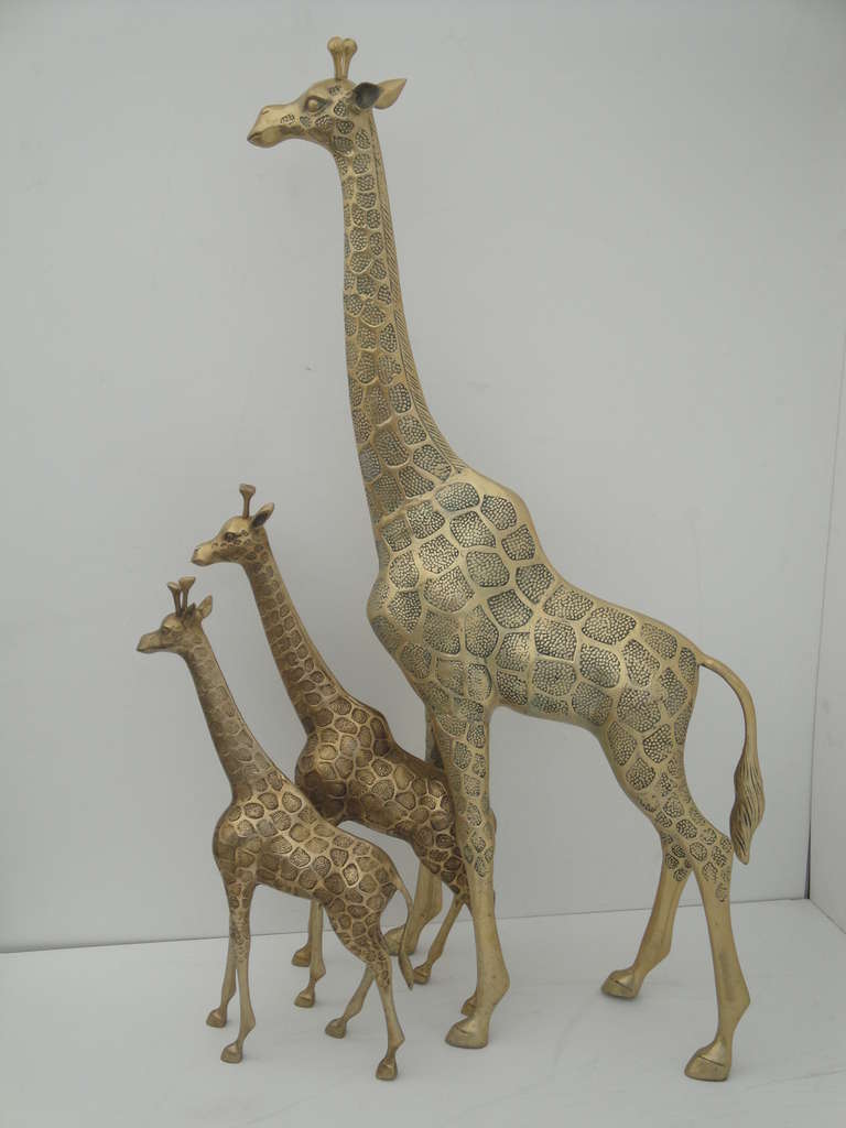 Vintage solid brass giraffe mother and two babies. 
Mother is 49