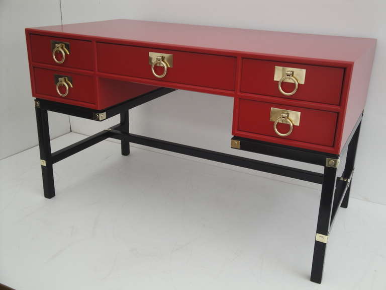 Hollywood Regency red Campaign style desk with brass hardware.