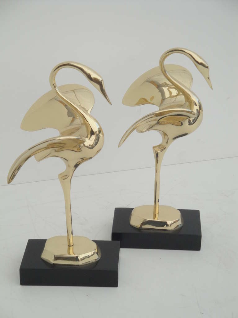 Pair of decorative polished brass modernist cranes.  Approximate measurements are of the crane and (base included in height)