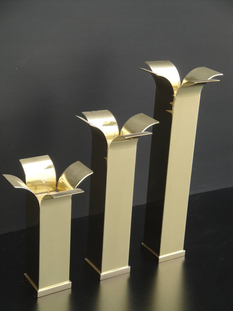 Set of Modernist polished brass candlestick holders.  Approximate dimensions are as follows:  
small = base W  2.75
