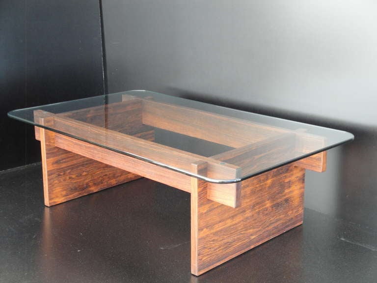 Mid century modern interlocking rosewood coffee table with half inch thick glass top. Actual  base is 45.5