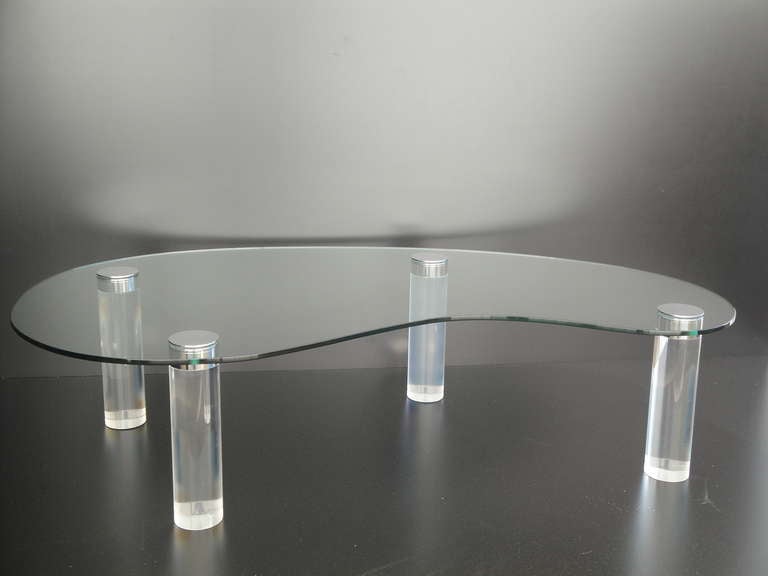 Lucite coffee table with kidney shaped half inch thick glass top.
Legs are made of 4