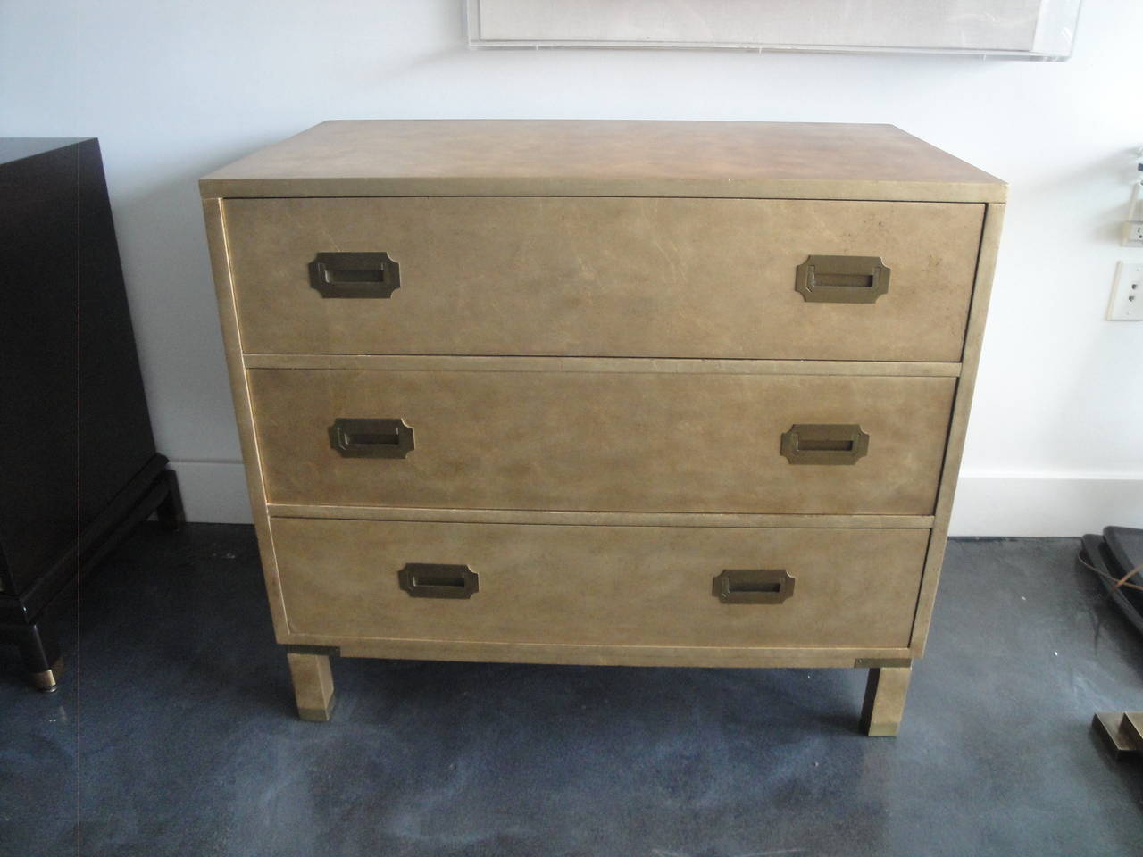Campaign style gold leafed chest of drawers by Baker Furniture Company.