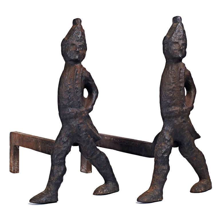 A pair of wrought iron andirons in the form of Hessian soldiers.  American, circa late 1930s. Stamped ‘Virginia Metalcrafters Waynesboro, Virginia’. 

Good vintage condition, recently cleaned.