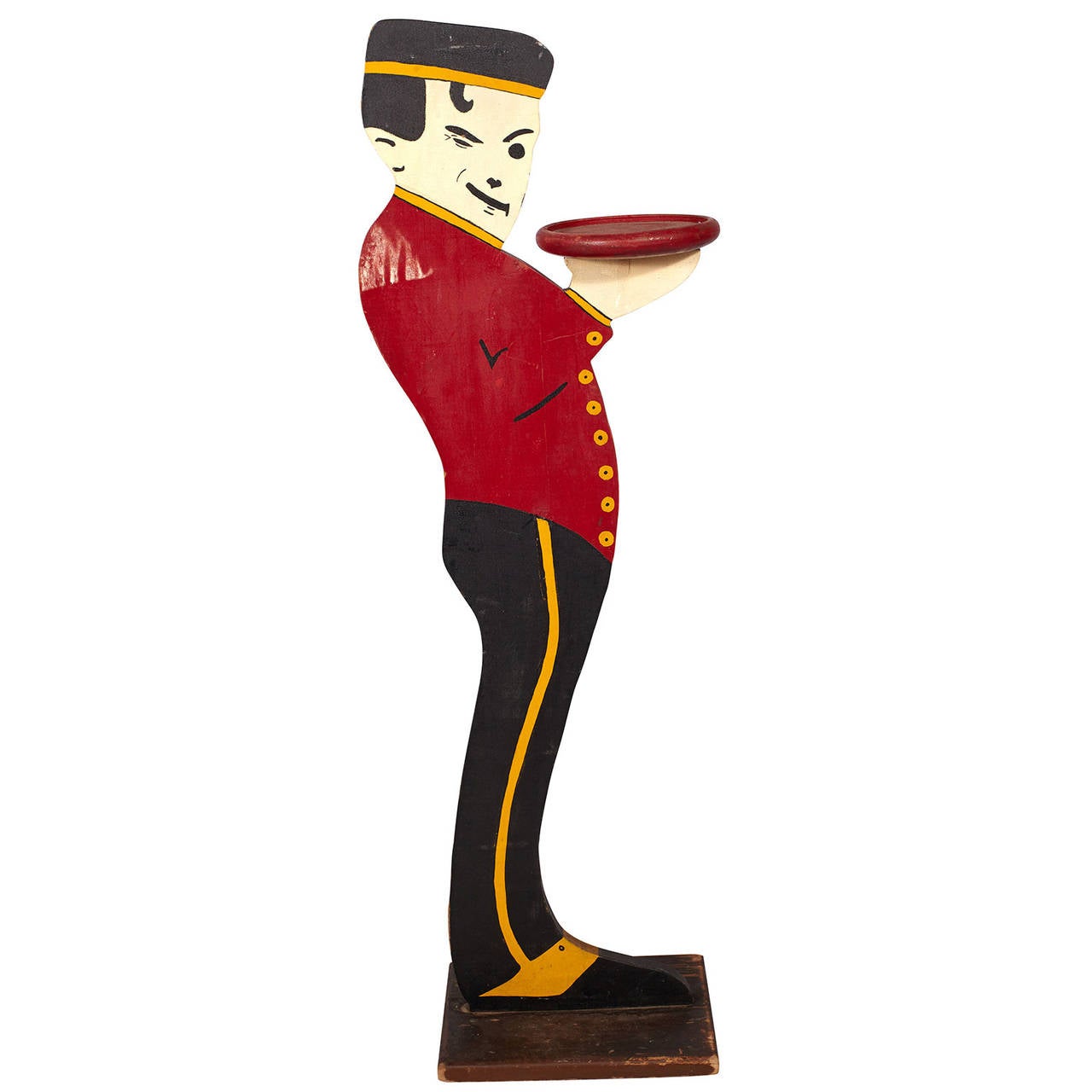 A vintage pedestal of a winking bellhop holding a tray; original paint on wood. Both sides of piece are painted.