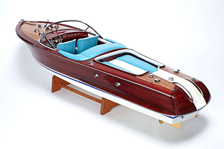 An original, vintage, beautiful mahogany, speedster boat model with hand stitched aqua and white leather seating and plank-on-frame wood boat construction; modeled after the infamous Riva Aquarama by Carlo Riva. Italian, circa 1960s.