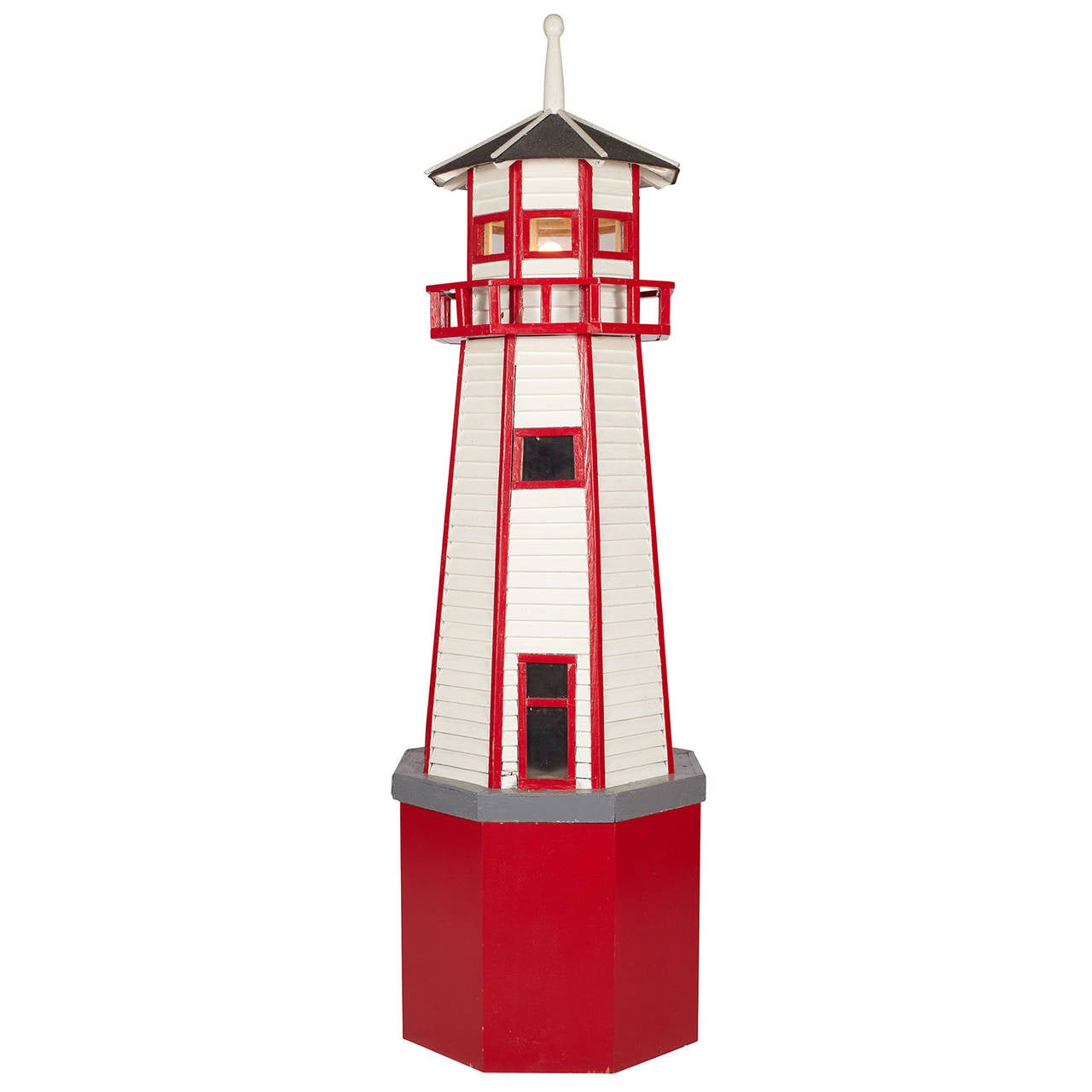 A large, handcrafted floor lamp model of a lighthouse with red trim and a white body, American, circa 1940. Also has wooden red painted base.