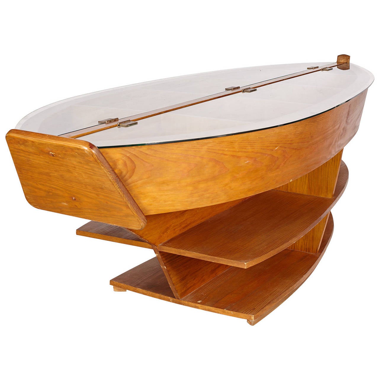 A beautiful table or library case in the form of a boat. Shelving on both sides. Glass top on hinges with shallow compartment storage under.