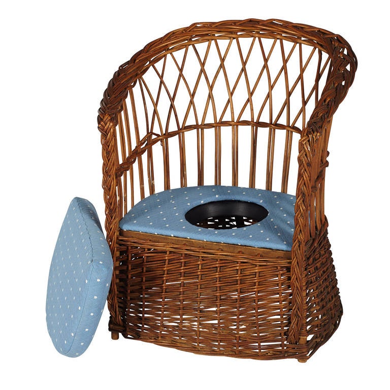 19th century wicker children's potty chair with a custom-made removable seat cushion.