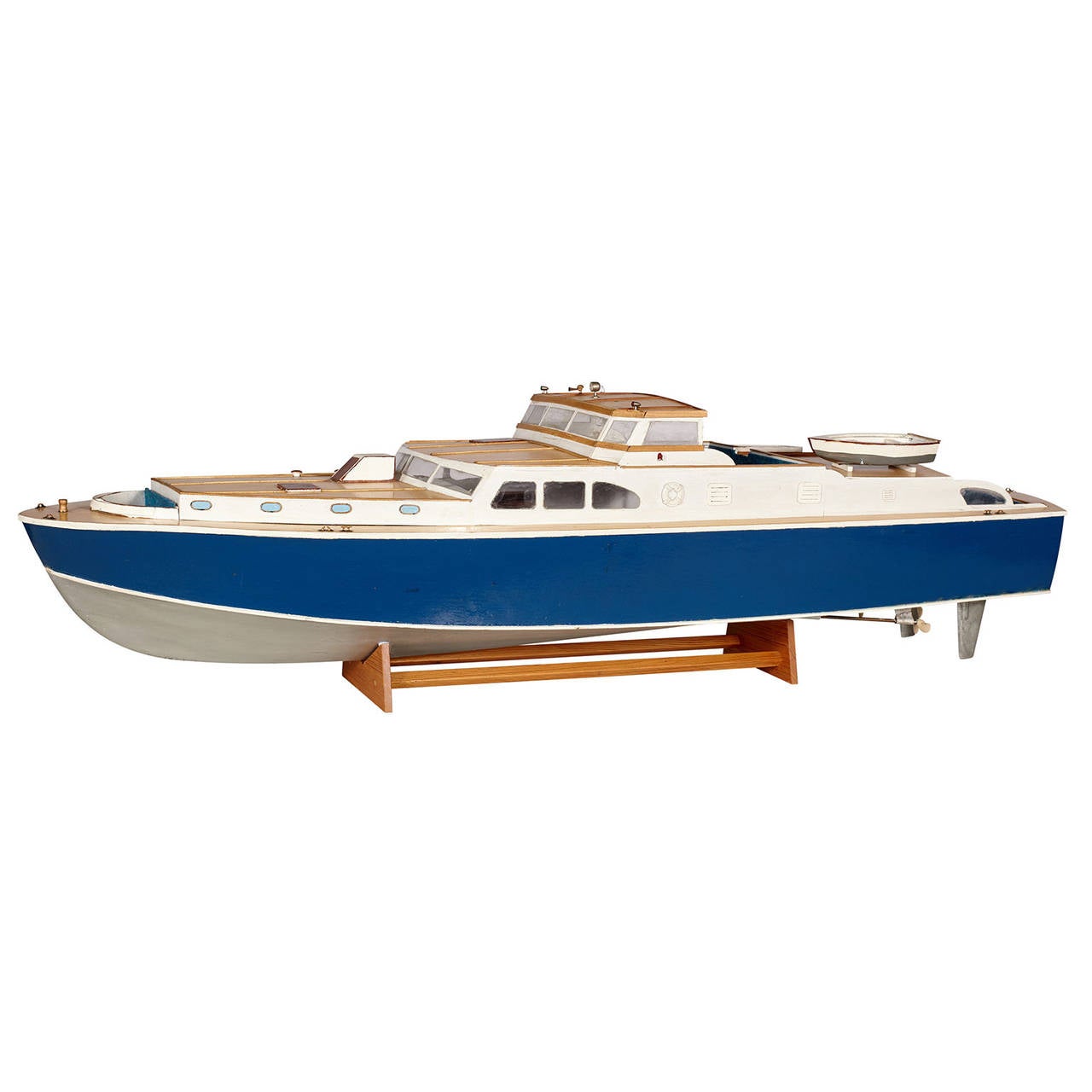Cabin cruiser boat model with wooden stand.
