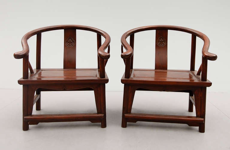 These two low chairs with curved backrest are from the first half of the 20th century,
In the middle of the backrest is a carved medallion.