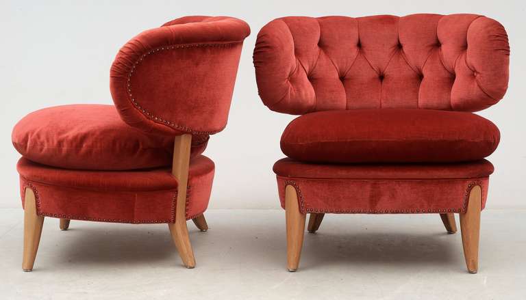 These two chairs by Otto Schultz were designed for Jio Möbler, Sweden, in the 1940's. 
The chairs are covered with red velvet and they are very well preserved. In addition, there is a seat cushion. The backrest is wide spreading and thereby