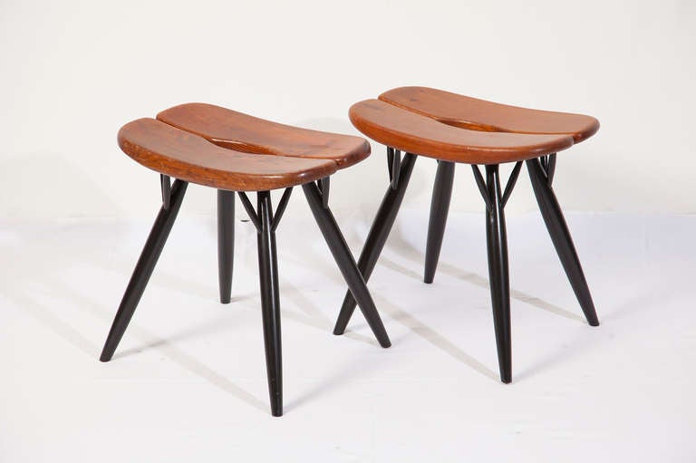 This pair of Pirkka stools, produced by Laukaan Puu in the 1950's is in a good original condition. 
The black legs and seats in stained pine result in a harmonic whole. The slightly curves wood seat invites for comfortable catches.
A finnish