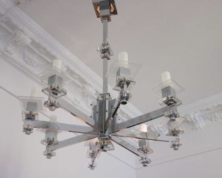 Chromed chandelier with two thick clear glass plates and one etched plate at each arm The small glass barrels which cover the bulbs are replaced.