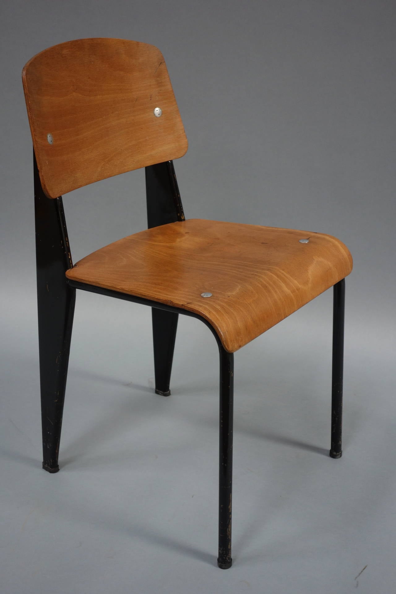 Standard Chair by Jean Prouvé (1901-1984), circa 1950

Black lacquered metal frame, bent plywood backrest and seat