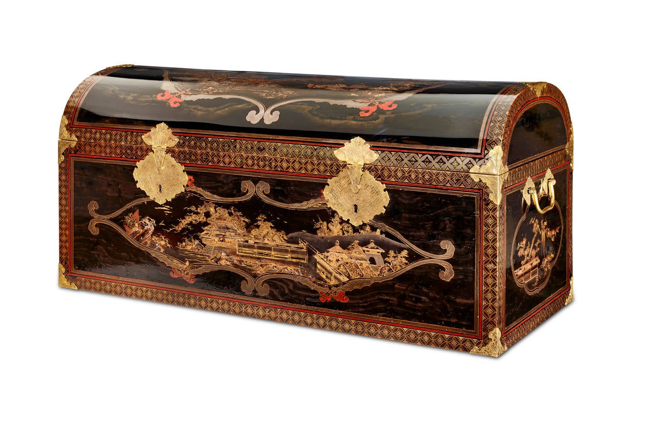 A rectangular Japanese transition style coffer with domed lid and gilded copper fittings. The decorations are in various techniques. The cartouches are on a rare wood grain ground called Mokume´ (a pattern to suggest the presense of wood grain). The