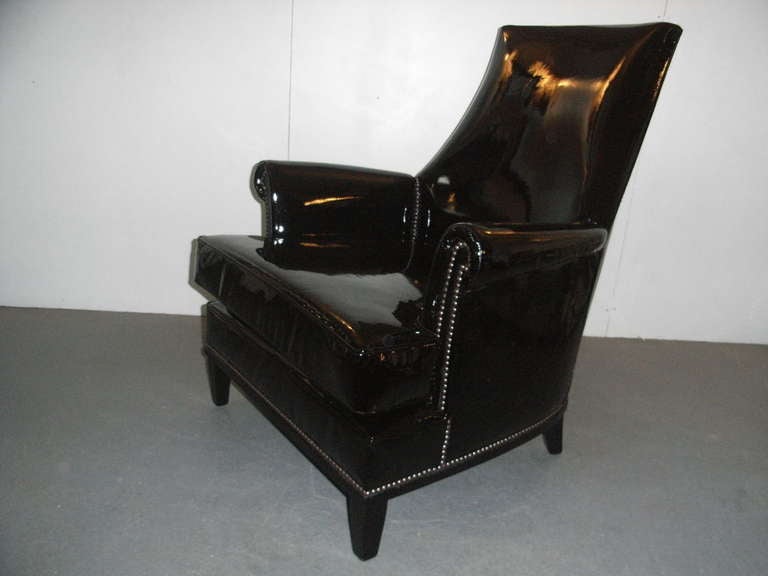 Pair of stylish armchairs with black lacquered wooden frames, reupholstered in black patent leather.

Item Location: London.

