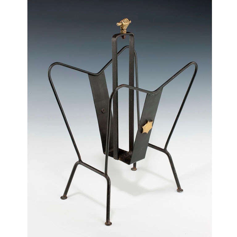 Black lacquered metal magazine rack with brass detail designed by Jacques Adnet. 