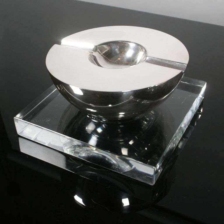 Solid silver lighter and ashtray sitting on a thick plexi stand.Signed Gucci, 1988 Italian