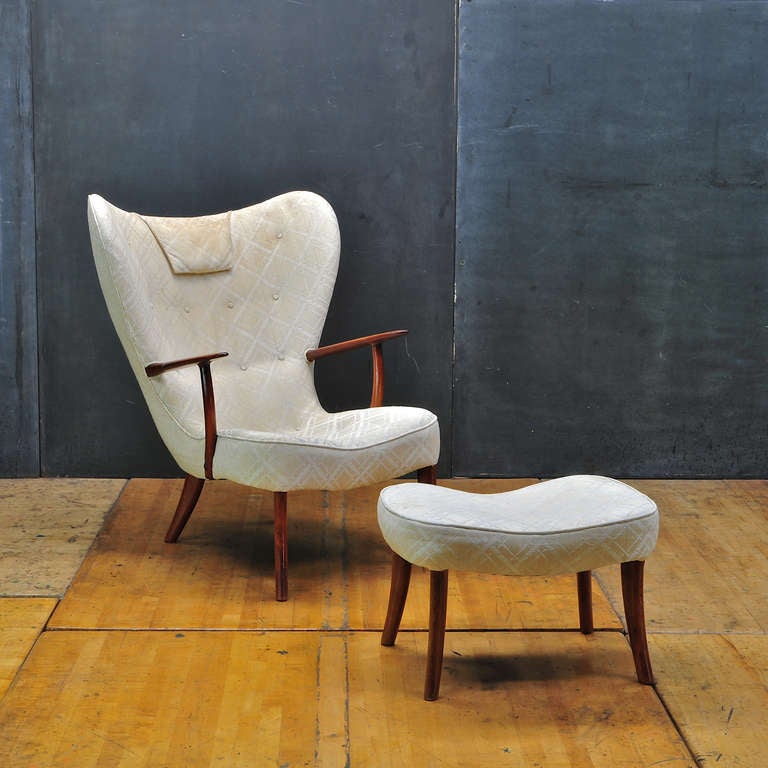 USA, c.1950s.  Unknown Designer/Maker.  A Wing Back Armchair with Original Pillow and Ottoman.  Splayed Leg Design, Oversized Proportions.  Sturdy, Rare Form.  Original Upholstery could be cleaned, Foam is good. 

Chair W: 32.25 x D: 35 xH: 39