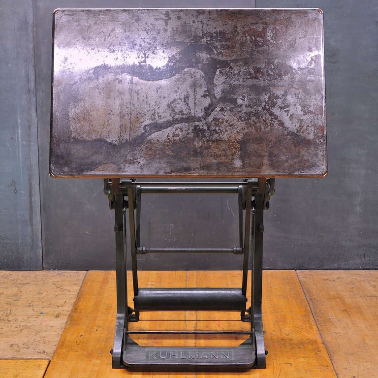 Kuhlmann Brand Architect Industrial Designer Engineers Drafting Table with Rolled Steel Top. Heavy Patina to all Surfaces, Fairly Smooth Work Area. Brass and Steel Detailings, Various Positions. Very Good Vintage Condition, Fully Functional.

W: