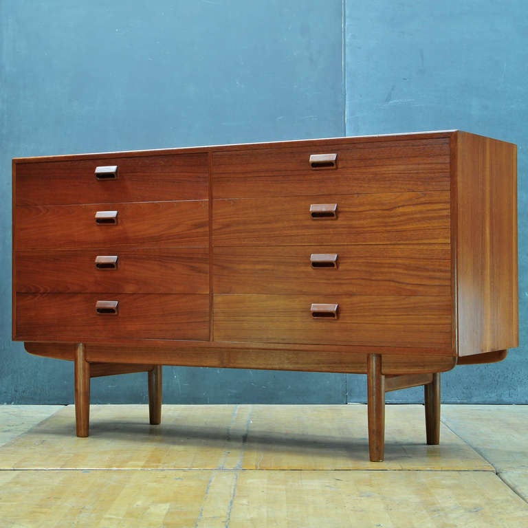 Iconic Danish Teak Chest of Eight Drawers.  Active Grain, Accentuated with Book Matched Drawer Faces.  Excellent Craftsmanship, Details.

W: 59 x D: 18¼ x H: 34½ in.
