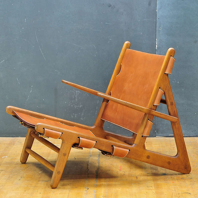 A very rare hand produced and retains original paper labeled remnants, hunting chair. Handmade by Erhard Rasmussen in 1948-1950 for Borge Mogensen. Retains most of original labels, the original brass sling hardware, with newly upholstered with