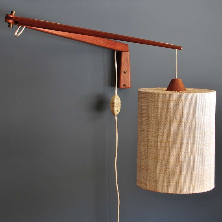 Rare Teak Articulate Segmented Wall Mount Lamps. 

In the manner of Uno and Osten Kristiansson for Luxus Vittsjö. Very Good Vintage Condition, Fully Functional.

Dia: 8 x H: 10 in. (Segment W: 20 Each in.) (Fully Extended: 41½ in.)