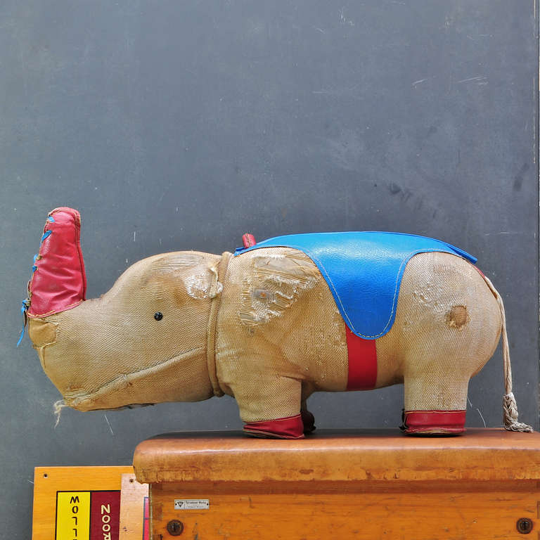 Very Rare 1960's Rhinoceros designed by Renate Muller as a thera­peu­tic toy. Muller con­tin­ues to hand-produce these in very lim­ited quantity. This example manufactured by H. Josef Leven KG, Sonneberg. 

Brown Gunny Sack, Blue and Red Leather,