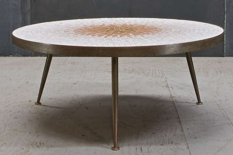 A rare mosaic topped three legged coffee table by Gio Ponti (Attributed.) Three Independent Solid Brass Legs support this Brass Edge Banded Sunburst Patterned Ceramic Tile Circular Top. Appears to be Hand Made, No Makers Mark, but Illegible Pencil