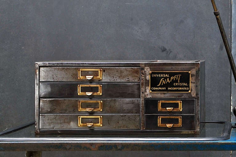 Vintage Industrial Machinists Atelier Petite Tabletop Cabinet. 6 shallow drawers with original brass drawer pulls label slots and heavy brass advertising makers brand.  Top Hatch for some type of lost Original Machinery.  Enamel Paint, Stripped and