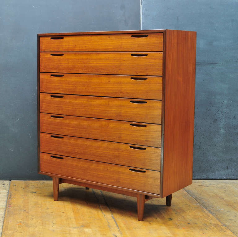 This Rare Mid-Century Modern 1950s Tall Teak Chest of Drawers (Bachelor) Dresser often Attributed to Ib Kofod Larsen. We have a matching Petite Credenza with burnished marks indicating J.Clausen&Son, Brande Mobelfabrik, Denmark. 

Minimalist Inset