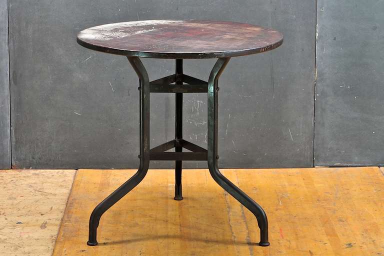 All original, with the original staved old growth hardwood round top heavily Patina'd, on time worn black enameled steel base. Fully intact, balanced and built like a tank. Retains original Toledo metal Furniture Mfg. Decaling.

Measure: Diameter