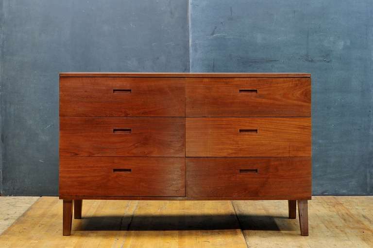 USA, circa 1950s. Unknown modernist craftsman slanted face solid walnut dresser. Handmade. Very old growth, deep hued, complex grained walnut. Excellent construction, smooth and fully functional. 

Two matching bedside cabinets/double drawer