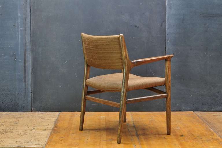 Hans J. Wegner model JH515, 1951. Executed by Carl Hansen, 1950s. Very active cross grain patterns in the arms and frame. In the original 1950s upholstery.