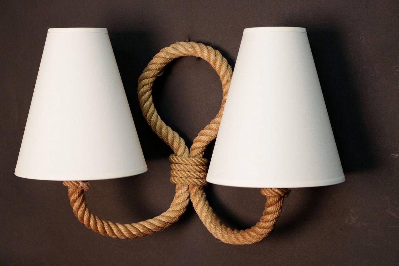 Pair of 1950's sconces by Adrien Audoux and Frida Minet. Decorated with two curved rope arms. Two light bulbs. New lamp shade.