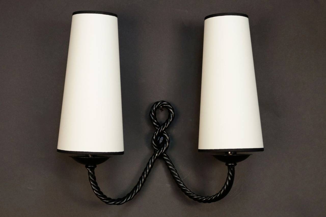 Large pair of 1959s 'Rope Manner' wrought iron sconces by Maison Lunel. Two-lighted arm per sconce. New tailored lamp shade with a black border.