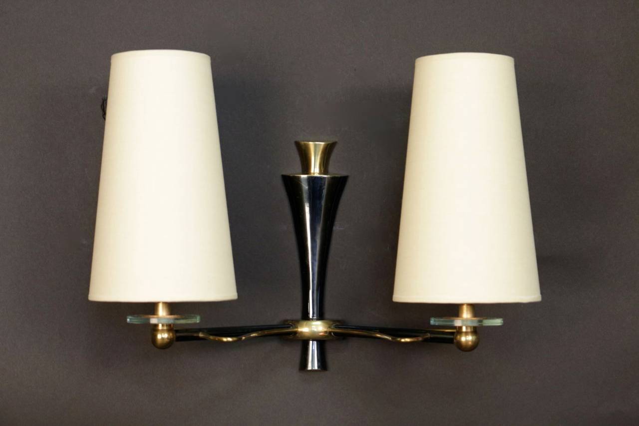 Pair of 1950's 'Butterfly Wings' sconces by Maison Lunel. In gilded and 'canon de fusil' brass and decorated with a glass disk. New tailored lamp shade. Two lighted arm per sconce.