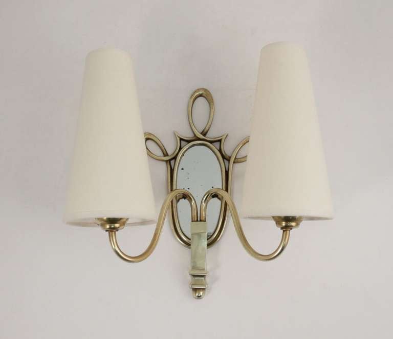 Pair of 1940s bronze mounted mirror sconces with two lighted arms. New shade. Wired for European use.